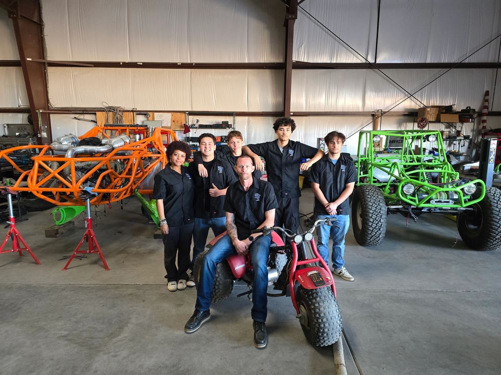 Ultra4Next students with race chassis in the shop