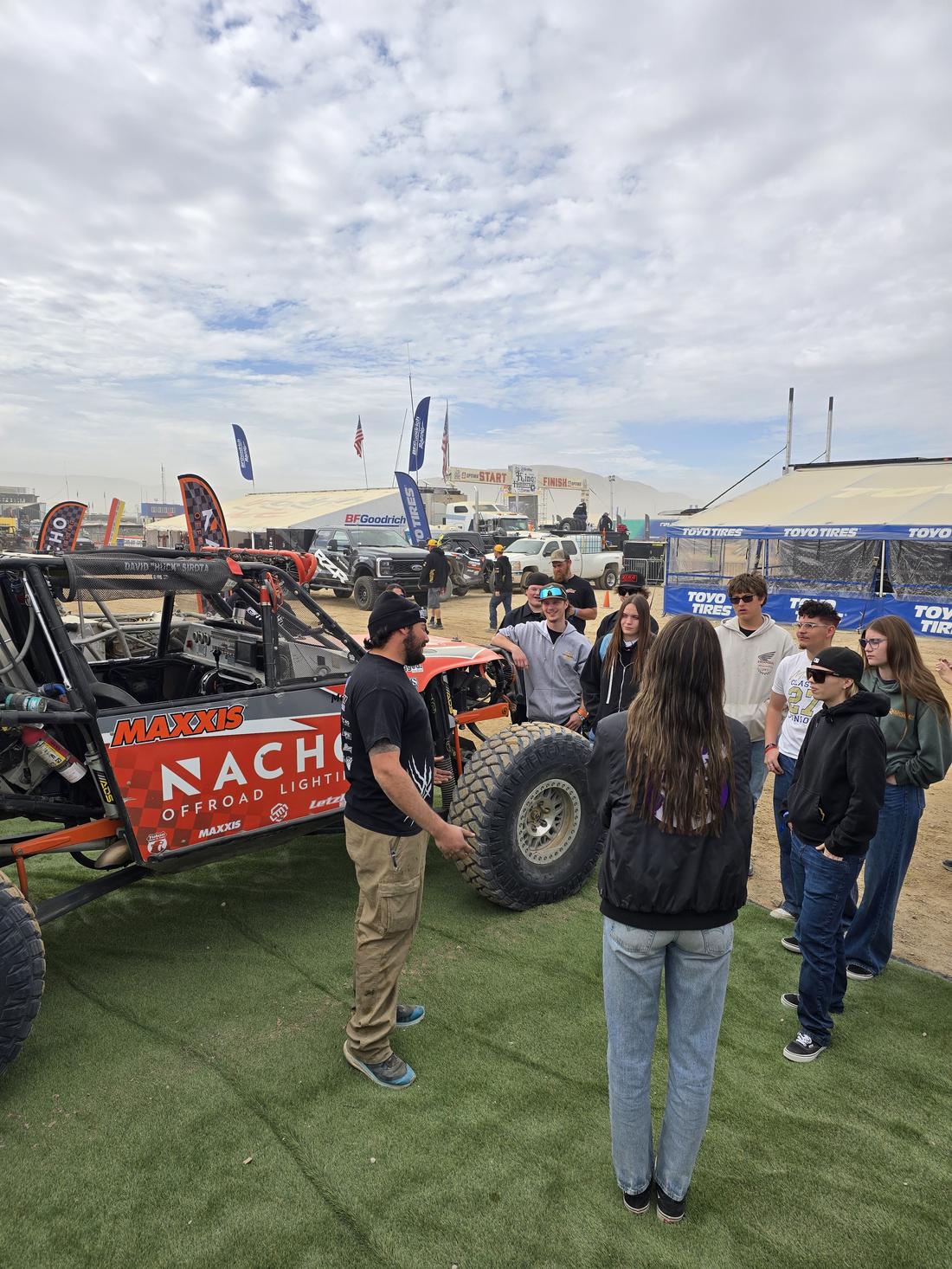 Students get a walkthrough at a race team pit