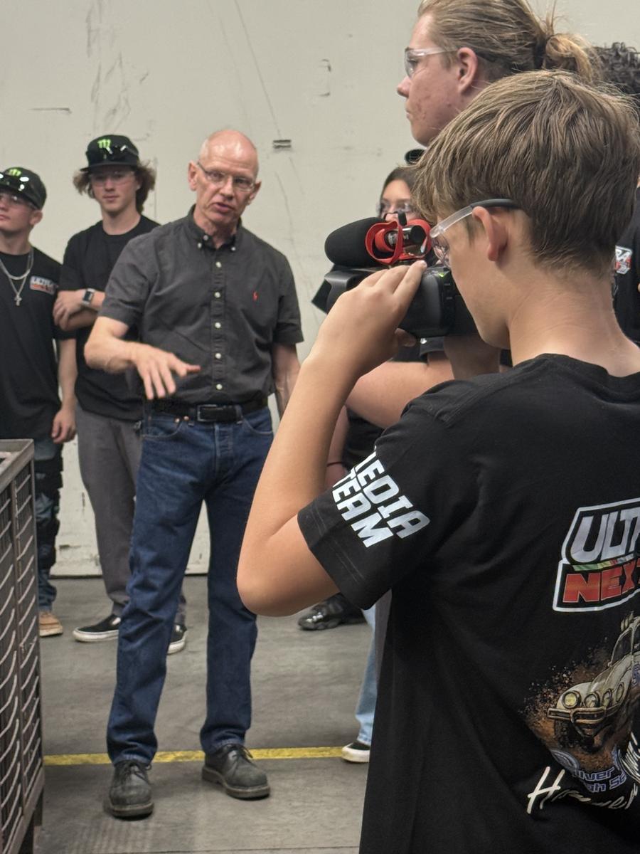A student films the tour for the media track