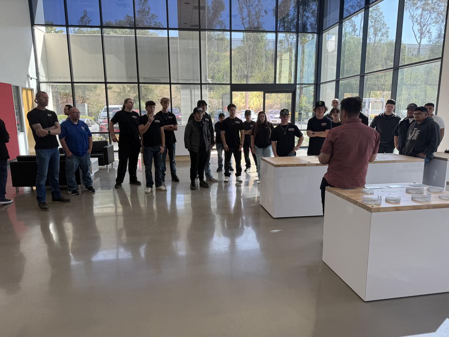 Students in the Eibach lobby with Mark Krumme, head of marketing, and Julian Gill, CEO